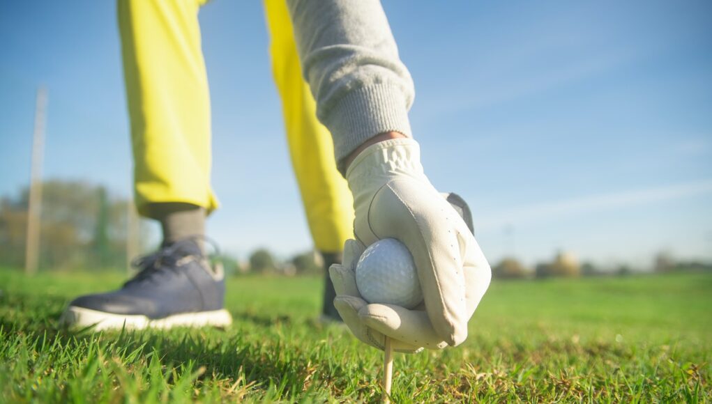 A Person Wearing a Glove while Holding a Golf Ball