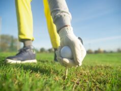 How to Survive Your First Game of Golf A Person Wearing a Glove while Holding a Golf Ball