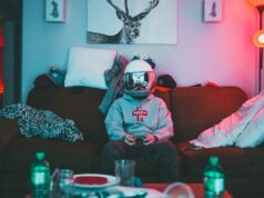 A Thorough Explanation on Making Money with NFT’s Boy in virtual reality helmet playing joystick