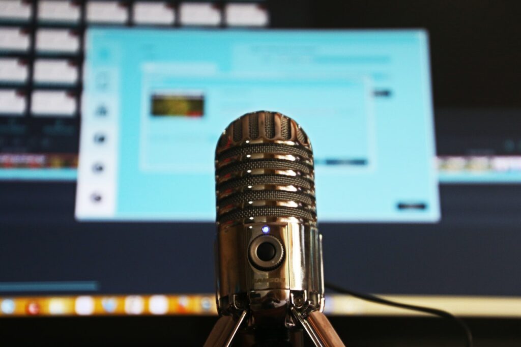 Podcast microphone with monitor in background