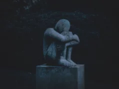 How Your Anxiety is Hurting Your Love And Sex Life man hugging his knee statue